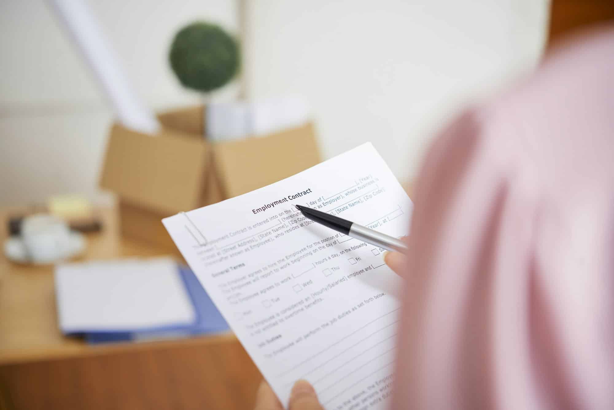 A woman reads an employment contract
